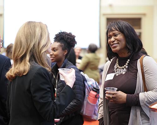 Two people talking at networking event.
